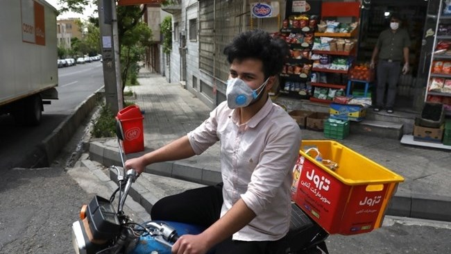 For some $15 a day, deliverymen don masks and gloves in Iran’s capital to zip across its pandemic-subdued streets to drop off groceries and food for those sheltering at home from the virus.